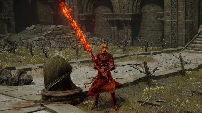 The Fire Knight Queelign stands with his large flaming greatsword in Elden Ring Shadow of the Erdtree.